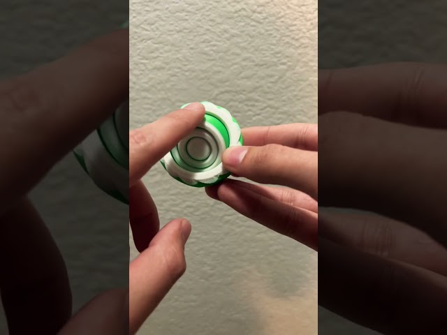 Satisfying 3D printed Gyro fidget spinner in Bambu Green and Jade White.