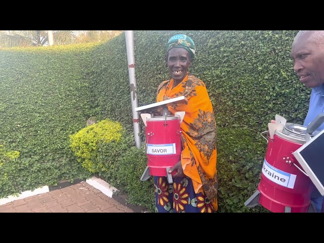 Donatha from Ruganaheza Co-op with "Savor" Cookstove