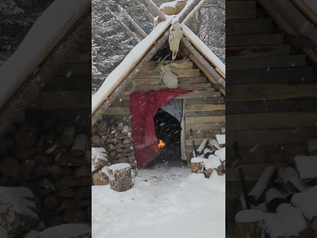 cozy fire during winter storm in my bushcraft shelter