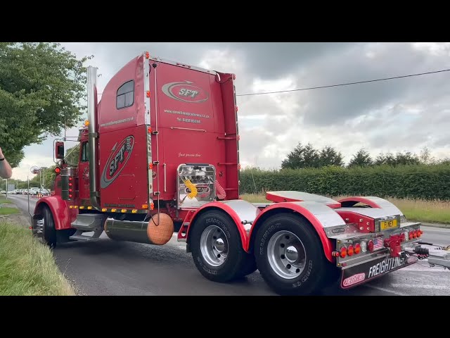 Trucks and cars leaving a car show, kelsall steam rally 2023