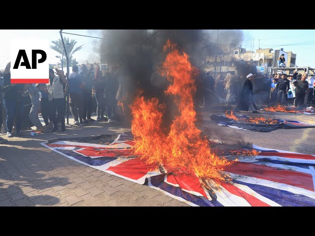 Iraq residents burn flags as they protest against the US, UK and Israel