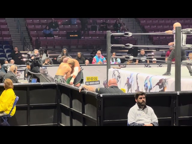 Samoa Joe slams Hook through the table