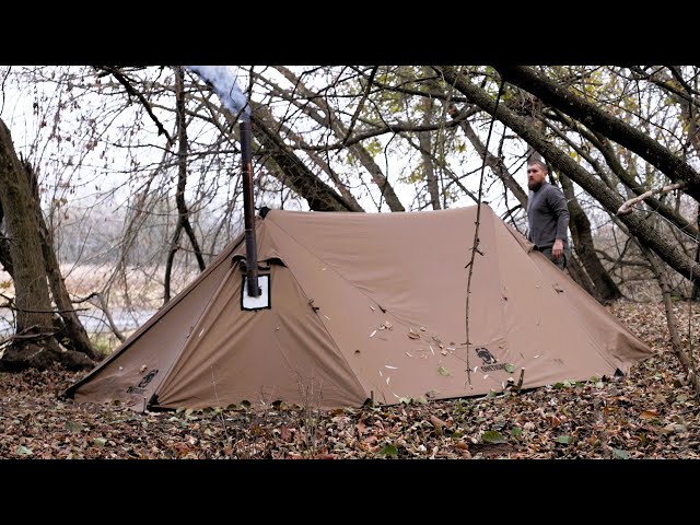 hiding from the rain in winter hot tent near moose den