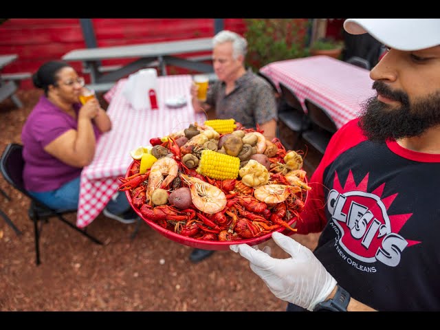 Eating with Ian at a seafood restaurant that feels like a backyard boil for a crawfish feast