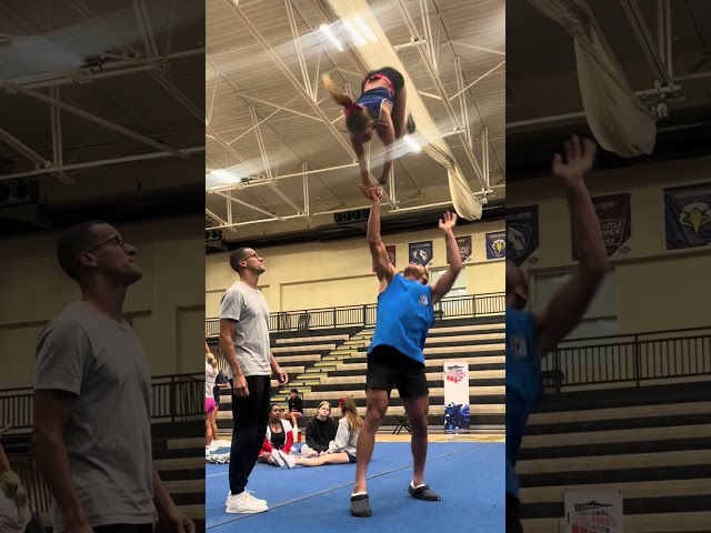 Cheerleaders are practicing a new coed skill!