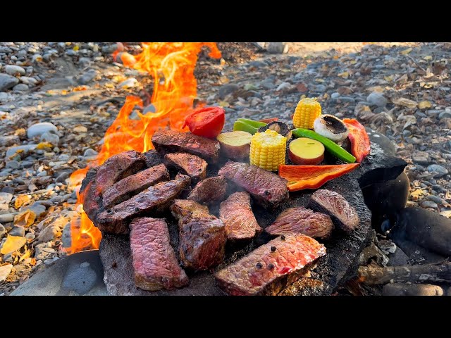 Whiskey-Marinated Steak Cooked on a Hot Stone & Tomato Salad.