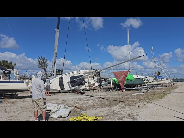 Crane Picking up Sailboat on Trailer