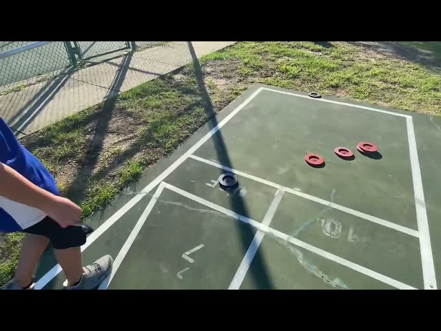 Kids learn to play shuffleboard for the first time