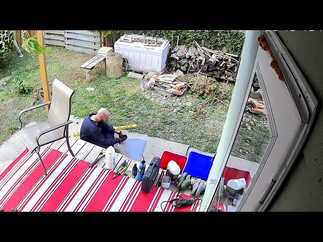 Wind Blows Chair Onto Man Working In Backyard - 1537131