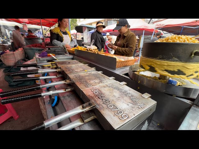 Yunnan, China. Food market: pig blood rice noodles, spicy fermented bean curd, bait, corn cakes