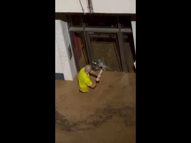 Man smashes glass door to save children in Spanish floods