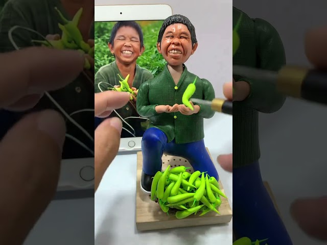 Old child picking peppers by hand, production process, clay figurines, handmade, old craftsmansh